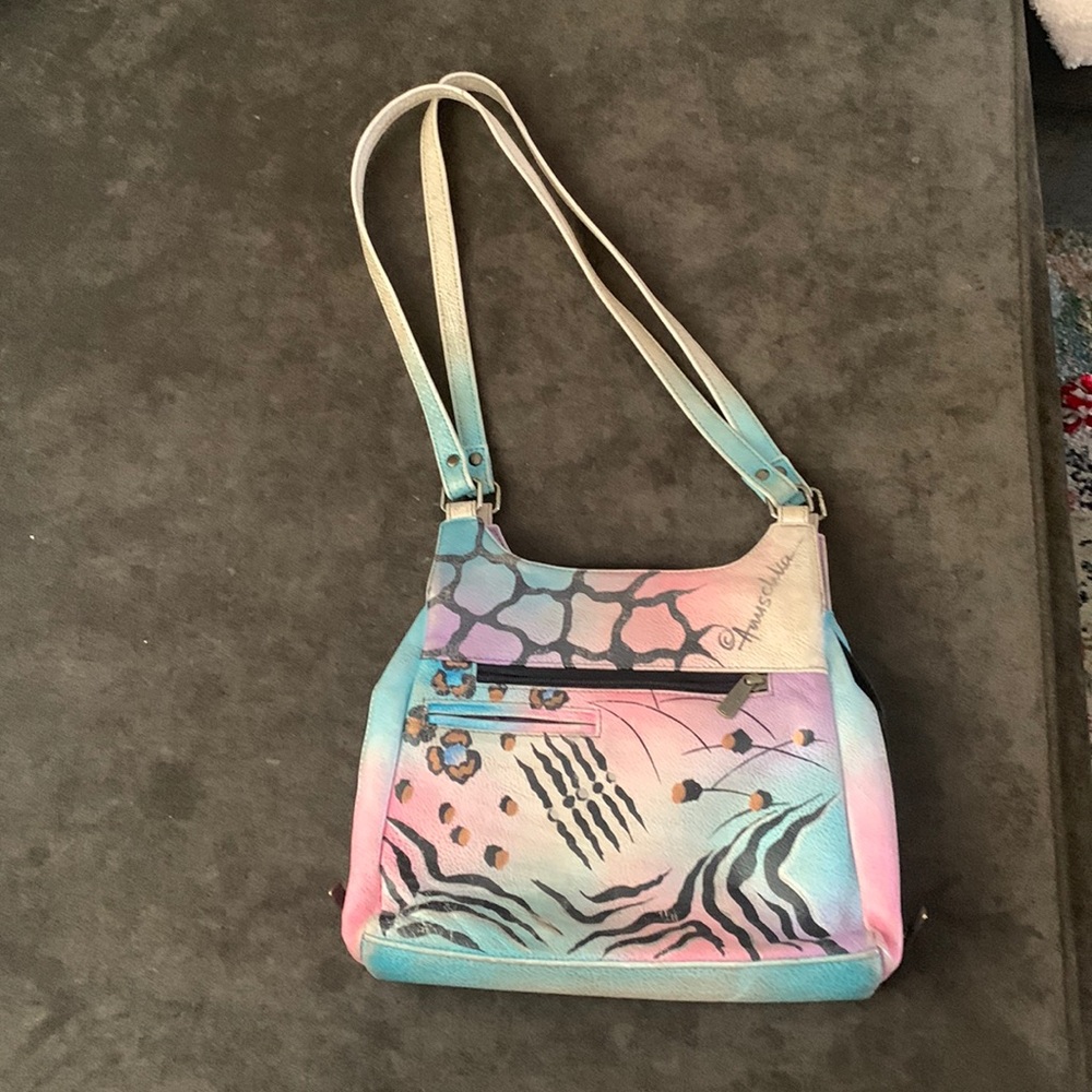 Hand painted original artwork. Genuine leather exterior and trim.